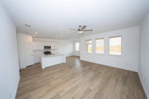 a view of a room with wooden floor