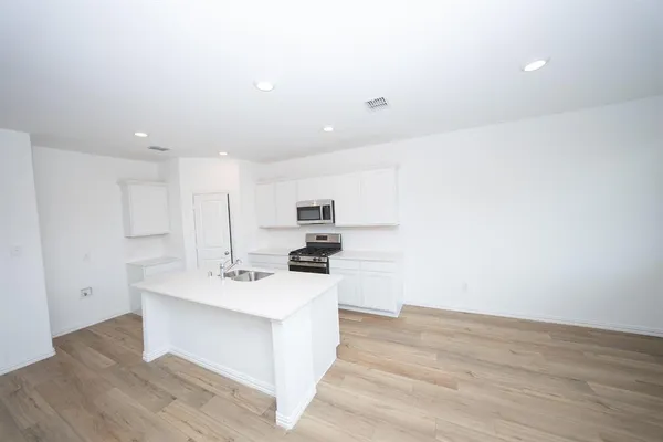 a view of kitchen with sink and wooden floor