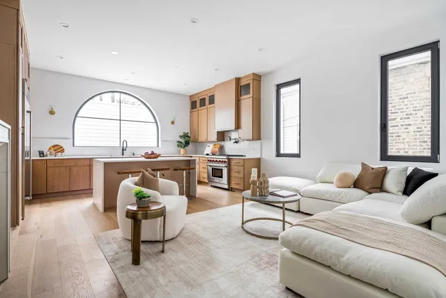 a kitchen with a sink a stove cabinets and a window