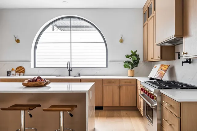 a open kitchen with stainless steel appliances granite countertop a sink stove and refrigerator