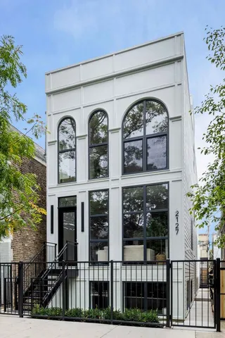 a living room with furniture a fireplace and a potted plant