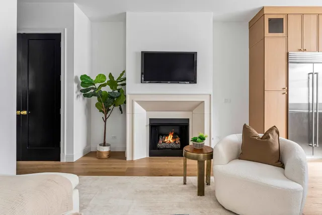 a bedroom with a bed a mirror and a large window with the outer view