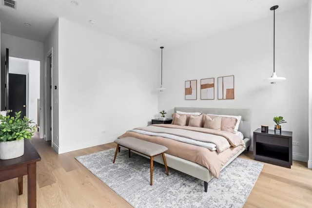 a bedroom with a bed and a large window