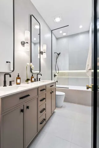 a bathroom with a sink a toilet and shower