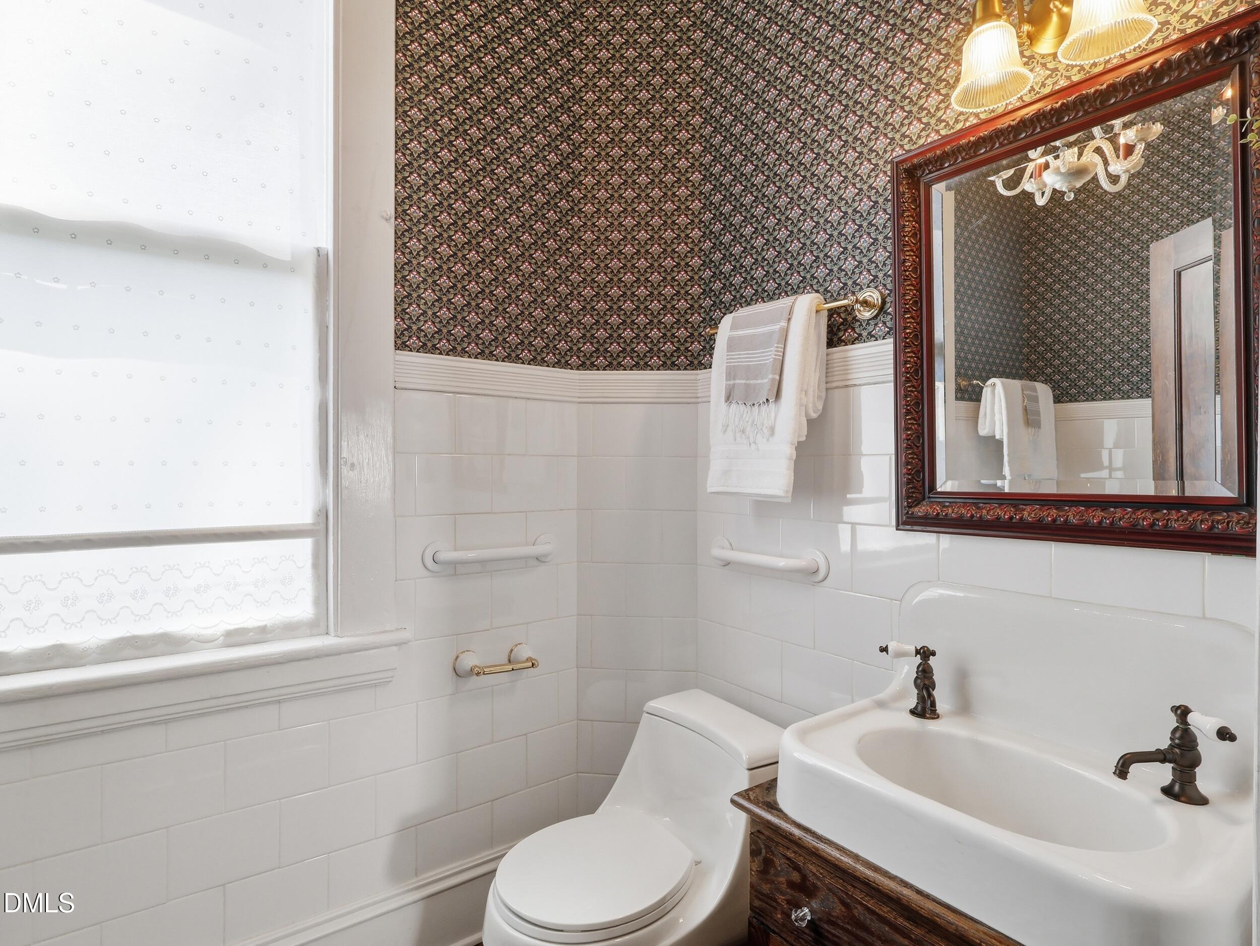 127 Forest Road Raleigh, NC 27605 - Photo 37 of 75 a bathroom with a sink mirror and toilet