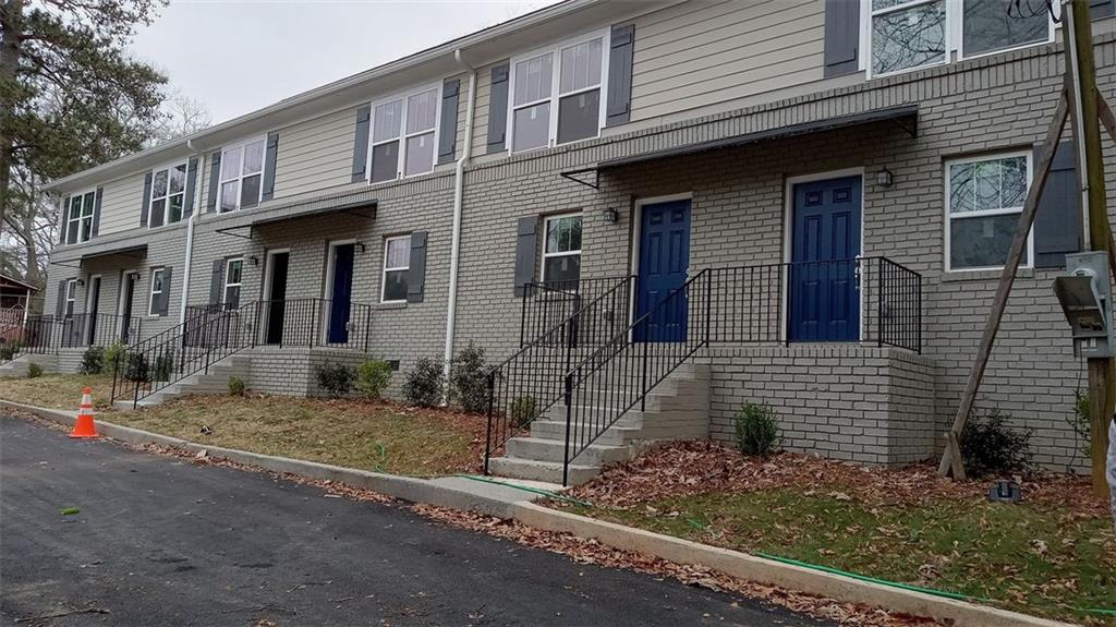 a view of a brick house with many windows