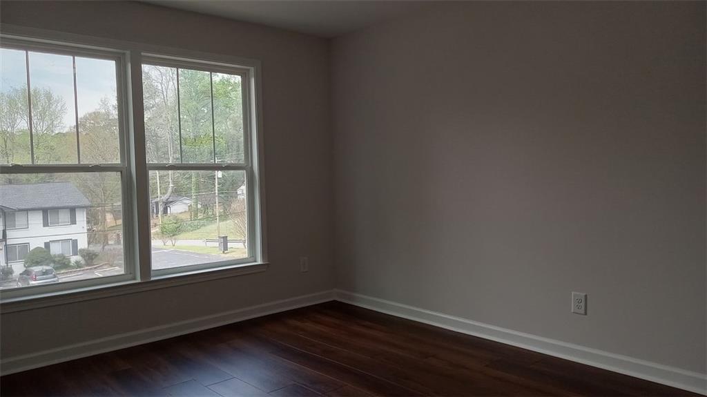 2156 Park Terrace, Unit 3 Atlanta, GA 30337 - Photo 19 of 29 a view of an empty room with wooden floor and a window