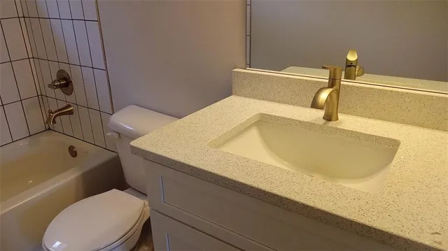 a bathroom with a bathtub and toilet