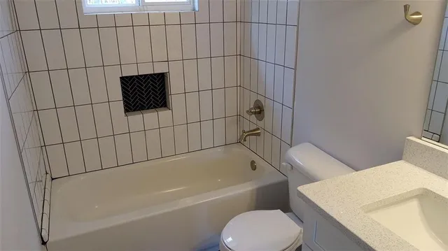 a bathroom with a toilet and a bathtub