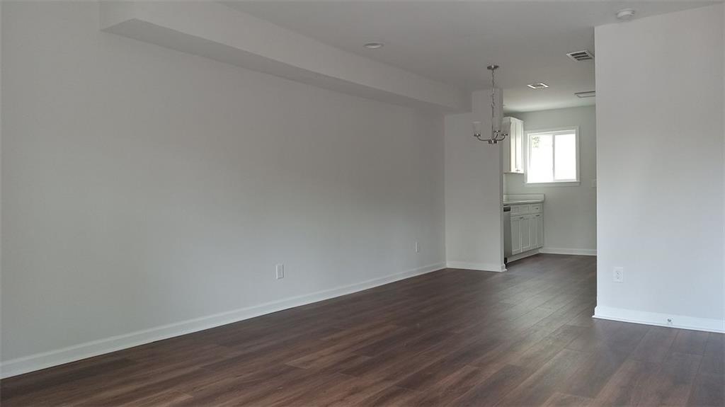 2156 Park Terrace, Unit 3 Atlanta, GA 30337 - Photo 3 of 29 a view of an empty room with wooden floor and a window
