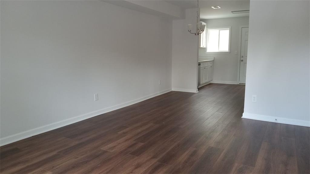 2156 Park Terrace, Unit 3 Atlanta, GA 30337 - Photo 4 of 29 a view of an empty room with wooden floor and a window