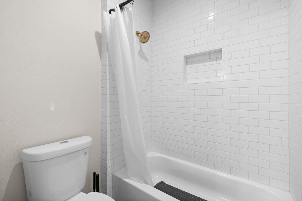 1703 County Road, Unit 217 Giddings, TX 78942 - Photo 15 of 19 Subway tile surrounds this classic tub and shower combination.
