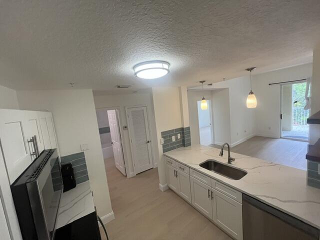 1155 Main Street, Unit 209 Jupiter, FL 33458 - Photo 4 of 10 a large white kitchen with a sink