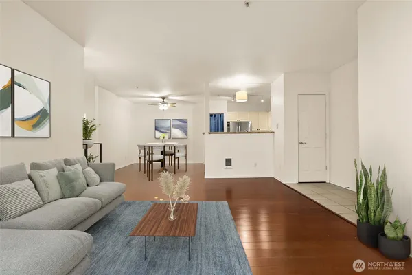 a living room with furniture and a wooden floor