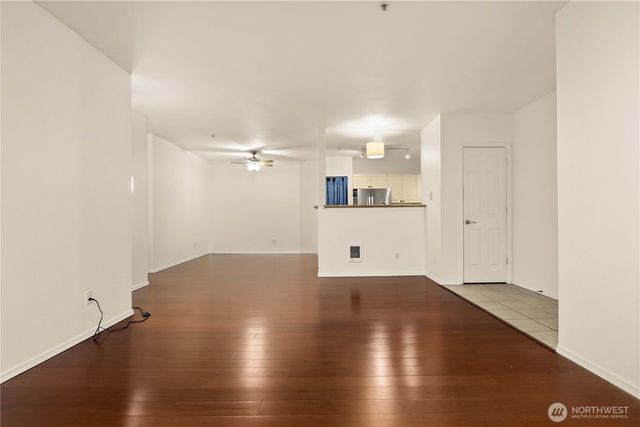 a view of a kitchen with a sink and a refrigerator