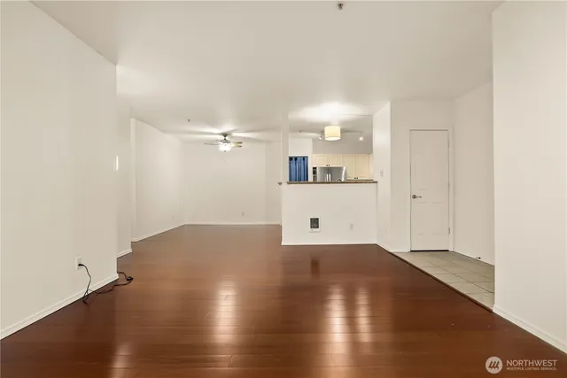 a view of a kitchen with a sink and a refrigerator