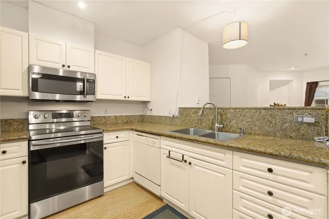 a view of a kitchen counter space and cabinets