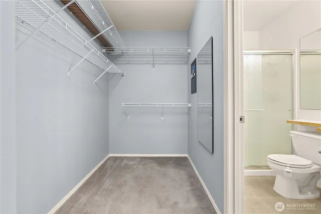 a bathroom with a granite countertop sink toilet and a mirror