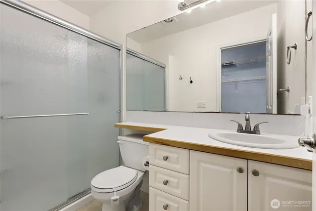 a bedroom with bed and a large mirror