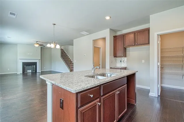 a kitchen with a counter top space cabinets and wooden floor