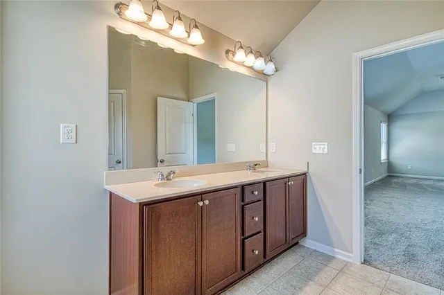 a bathroom with a double vanity sink and a mirror