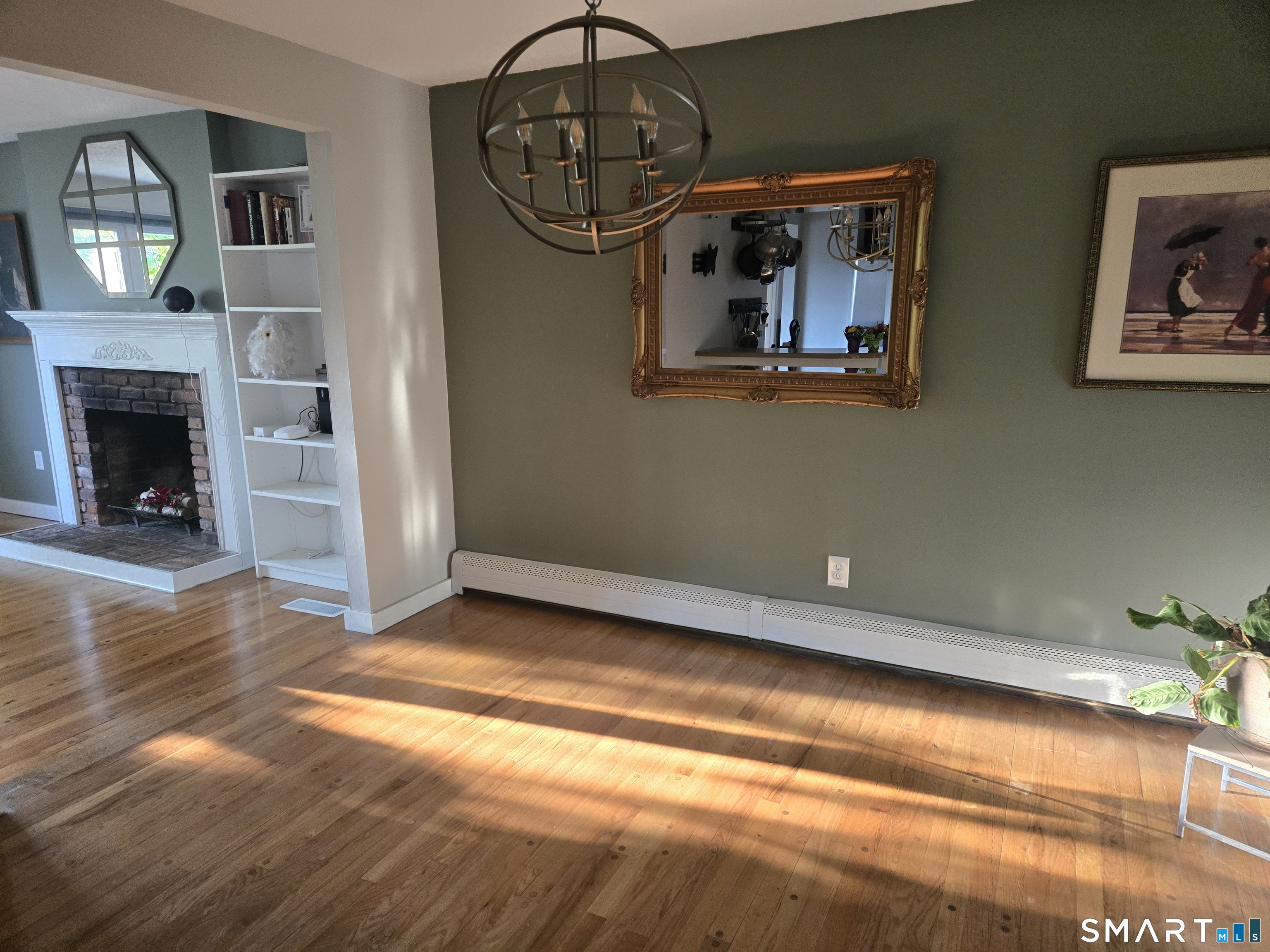1004 Hickory Hill Road Thomaston, CT 06787 - Photo 15 of 23 a view of empty room with wooden floor and fireplace