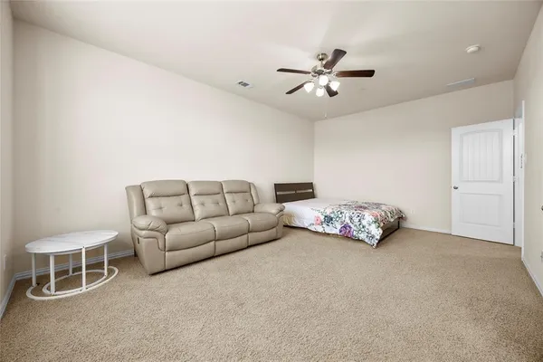 a bed room with a bed and a ceiling fan