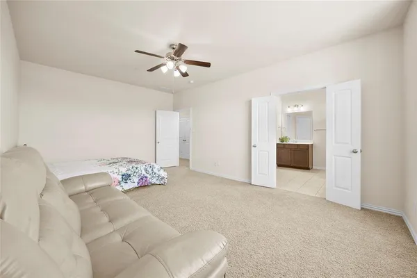 a spacious bathroom with a granite countertop sink a mirror and a vanity