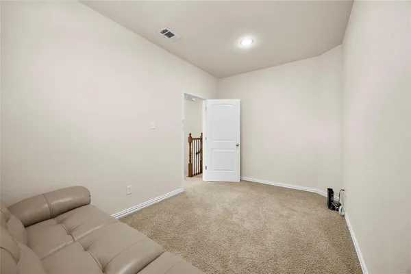 a bedroom with a bed window and lamp next to a window