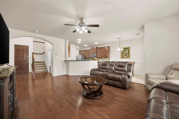 a living room with furniture and kitchen view