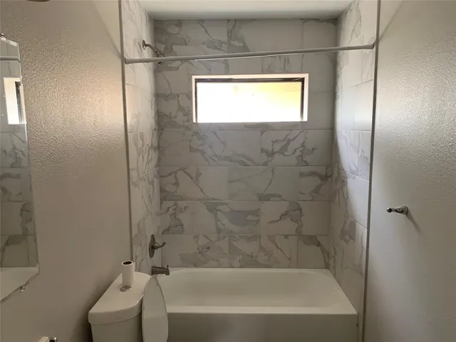 a bathroom with a bathtub and shower