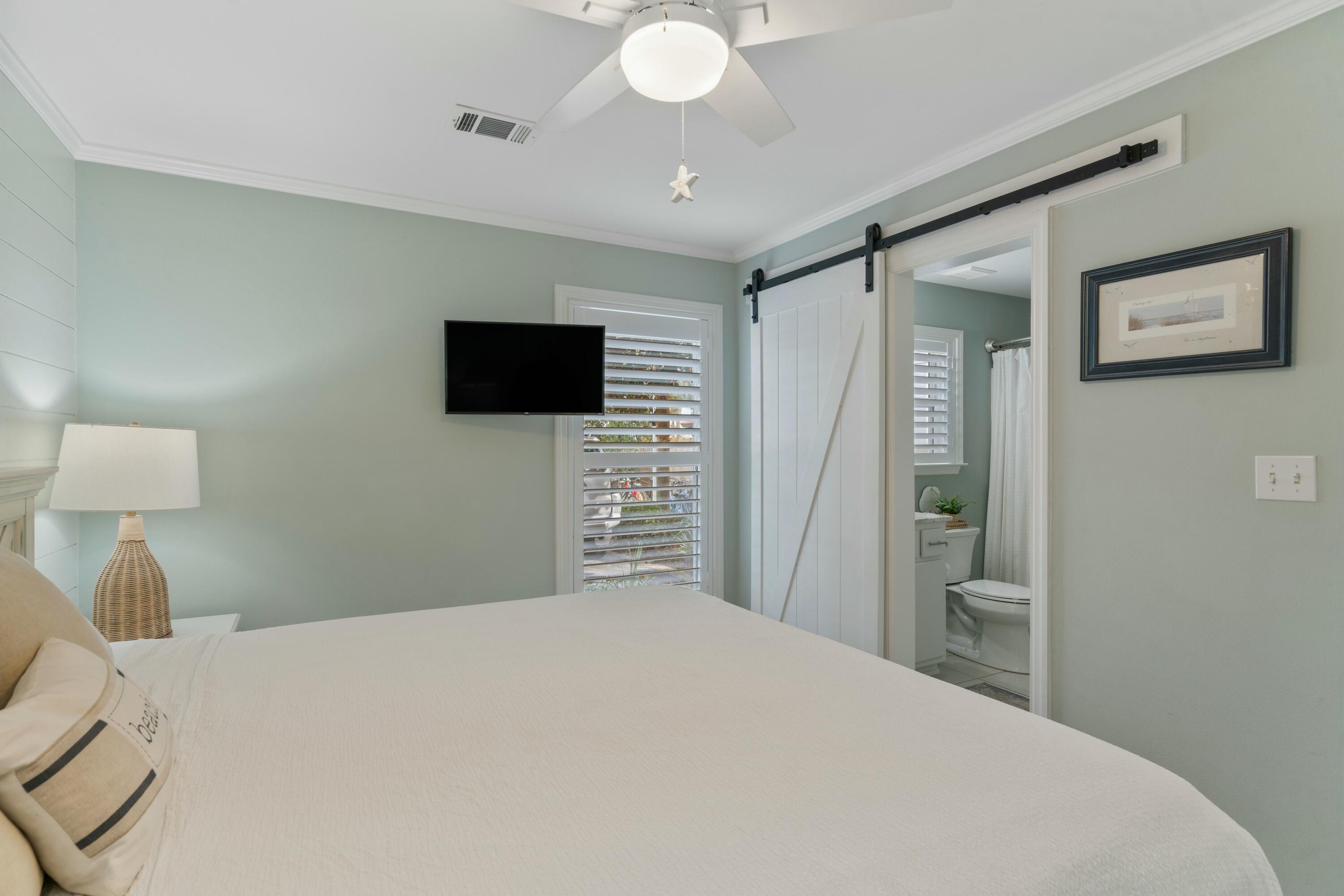 82 Sugar Sand Lane, Unit C1 Santa Rosa Beach, FL 32459 - Photo 11 of 29 a bedroom with a bed and a flat screen tv