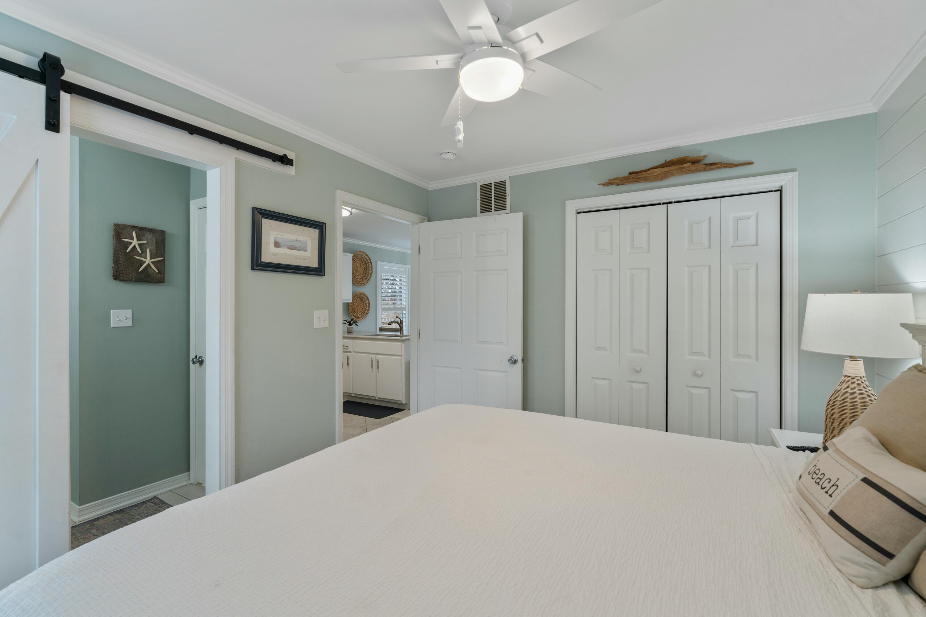 82 Sugar Sand Lane, Unit C1 Santa Rosa Beach, FL 32459 - Photo 12 of 29 a bedroom with a bed and a chandelier