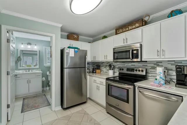 a kitchen with a refrigerator stove and sink