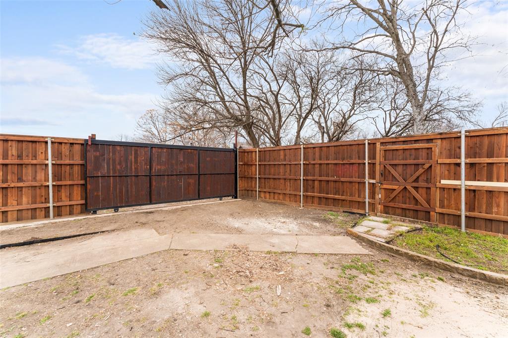 2530 Utica Drive Dallas, TX 75227 - Photo 29 of 37 a view of a backyard with wooden fence and large trees