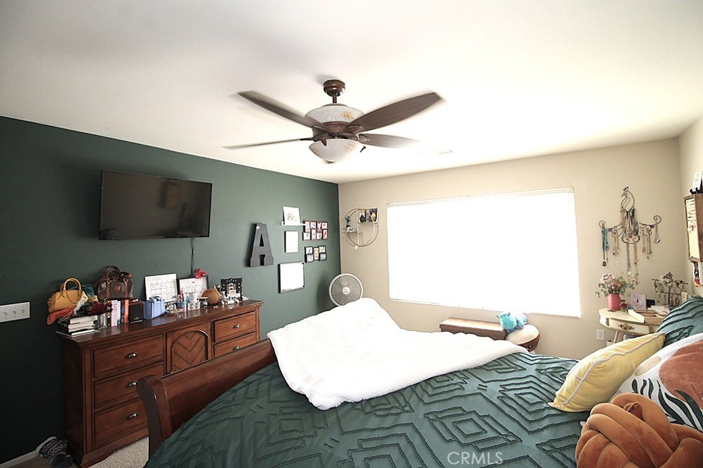 924 Condor Street Barstow, CA 92311 - Photo 32 of 52 a bed room with a bed window and a television