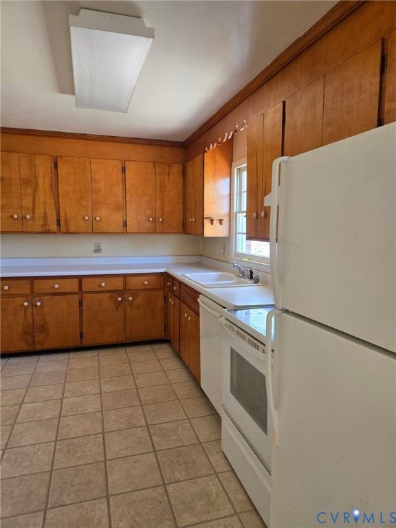 19247 Courthouse Road Yale, VA 23897 - Photo 6 of 6 Kitchen featuring white appliances, brown cabinets