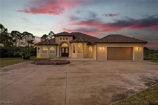 a front view of a house with a yard and garage