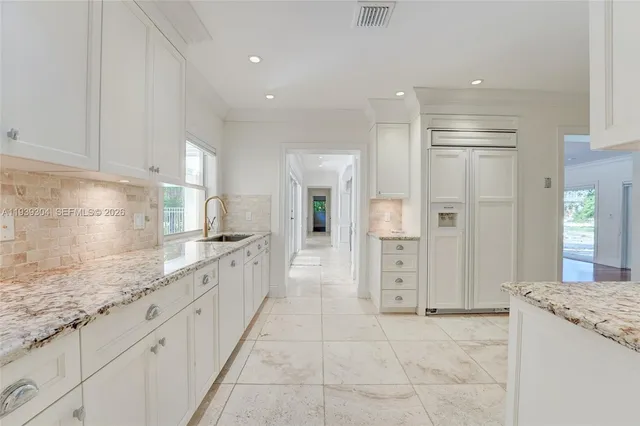 a bathroom with a granite countertop sink mirror and shower