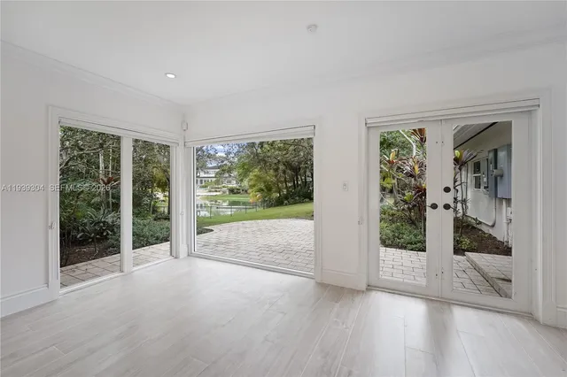 a view of empty room with wooden floor and fireplace