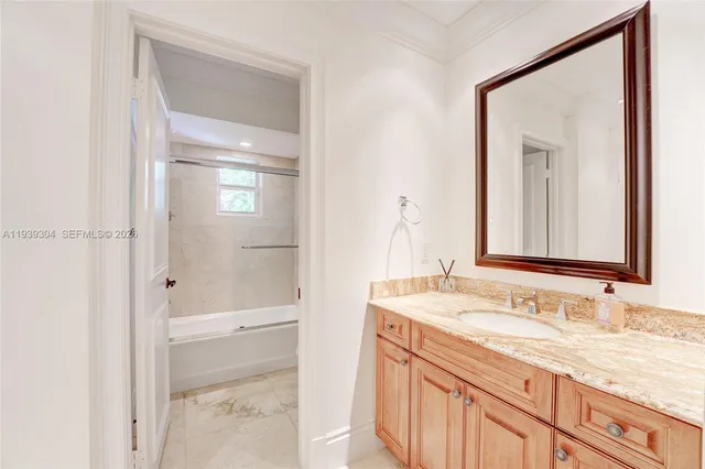 a bathroom with a sink vanity and toilet