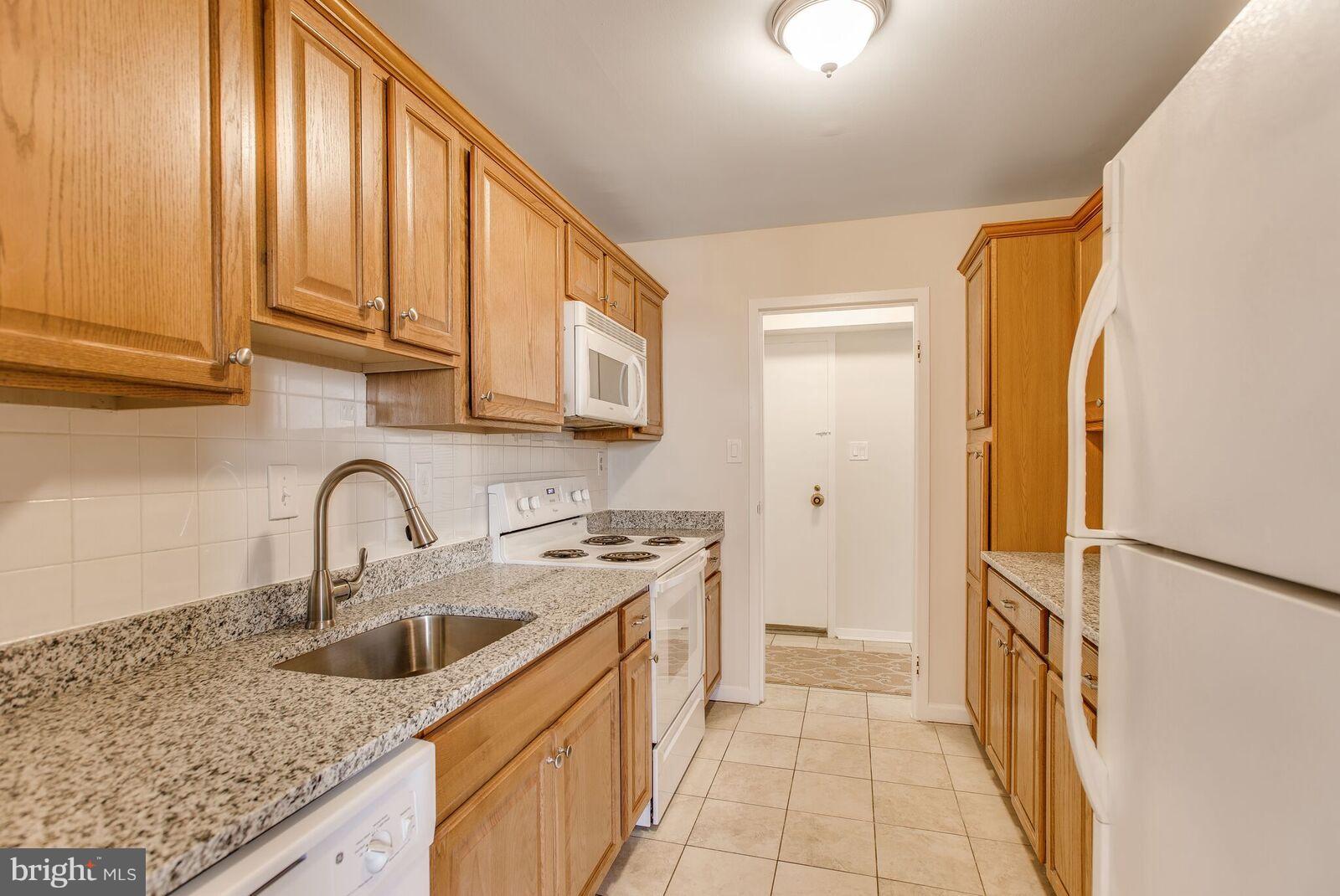 9701 Fields Road, Unit 2301 Gaithersburg, MD 20878 - Photo 5 of 21 Granite Kitchen with Wood Cabinetry