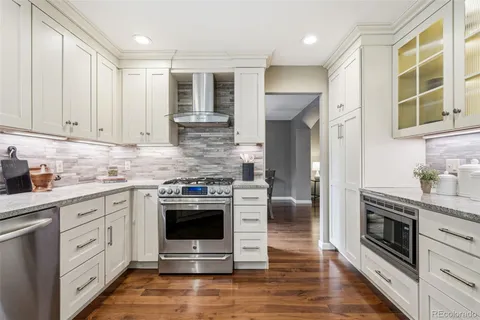 a kitchen with stainless steel appliances granite countertop a stove and a sink