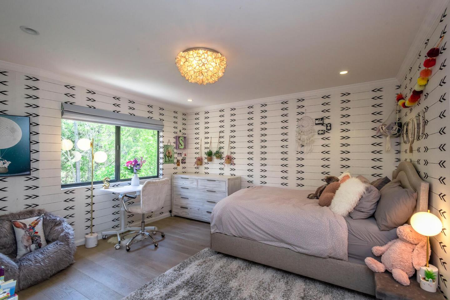 2651 Summit Drive Burlingame, CA 94010 - Photo 20 of 36 a bedroom with a bed and a chandelier