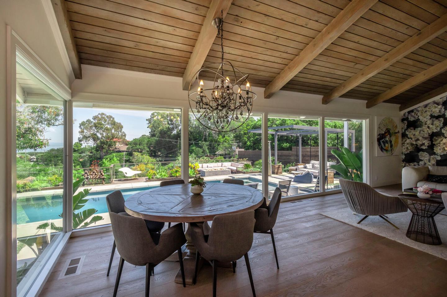 2651 Summit Drive Burlingame, CA 94010 - Photo 6 of 36 a view of a dining room with furniture wooden floor and a potted plant