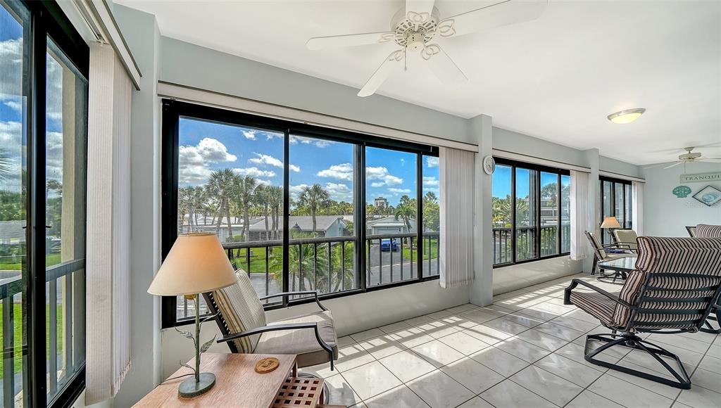225 Hour Glass Way, Unit 202 Sarasota, FL 34242 - Photo 14 of 68 a living room with furniture and a large window