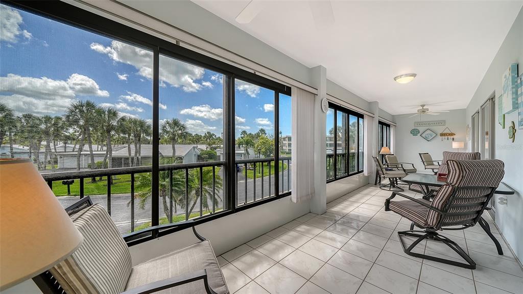 225 Hour Glass Way, Unit 202 Sarasota, FL 34242 - Photo 15 of 68 a view of a porch with furniture and garden