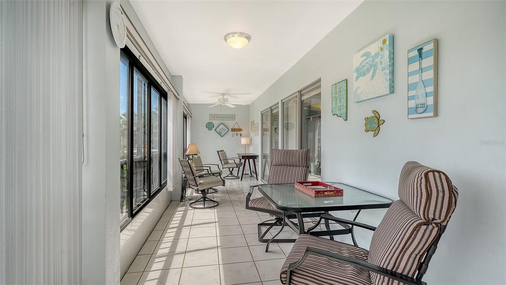 225 Hour Glass Way, Unit 202 Sarasota, FL 34242 - Photo 16 of 68 a view of a livingroom with furniture and window
