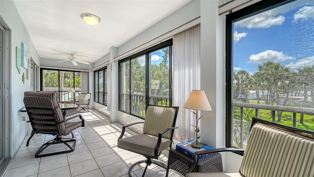 225 Hour Glass Way, Unit 202 Sarasota, FL 34242 - Photo 18 of 68 a living room with furniture and a large window