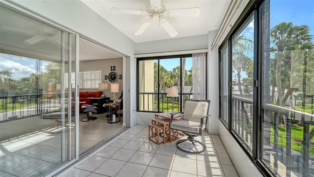 225 Hour Glass Way, Unit 202 Sarasota, FL 34242 - Photo 19 of 68 a living room with furniture and floor to ceiling windows